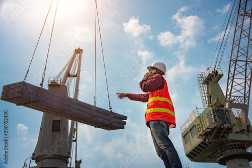 Konstfotografi worker, foreman, loading master or engineering works while keep talking on mobil