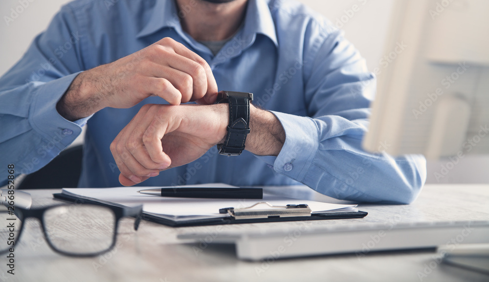 Businessman adjusting his wristwatch. Business concept Businessman adjusting his wristwatch. Business concept