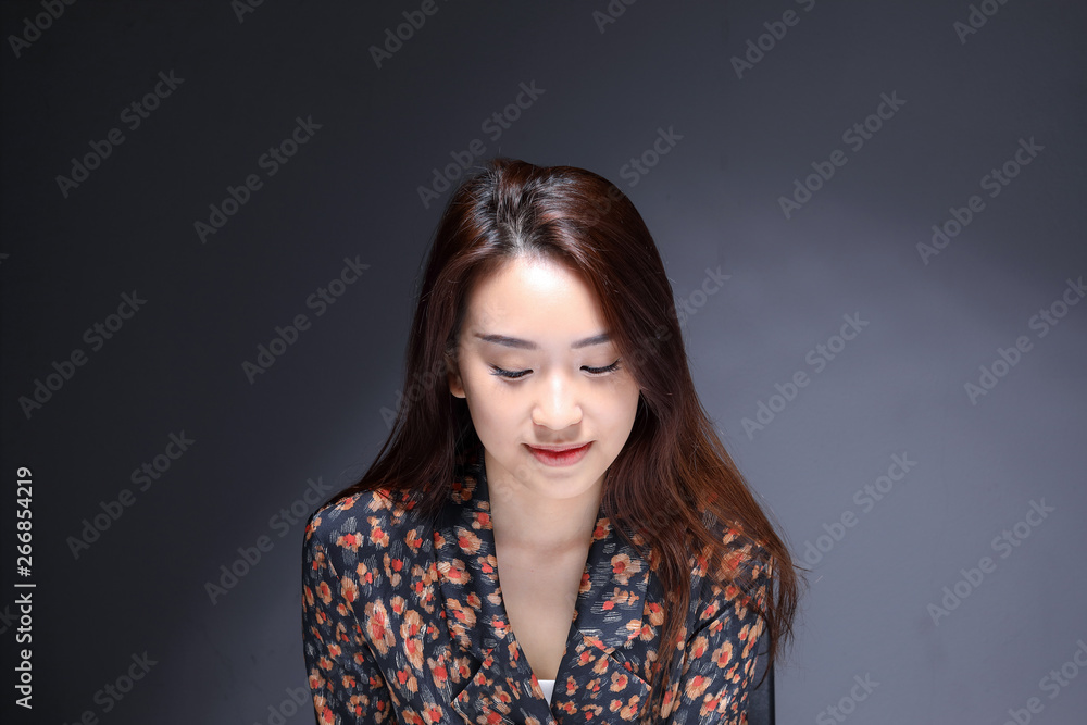 Young beautiful Asian woman makeup dark background Young beautiful Asian woman makeup dark background
