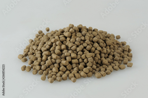 Small middle size swimming, floating fish food for aquarium and pond in round form light brown natural color for many kind of fishes