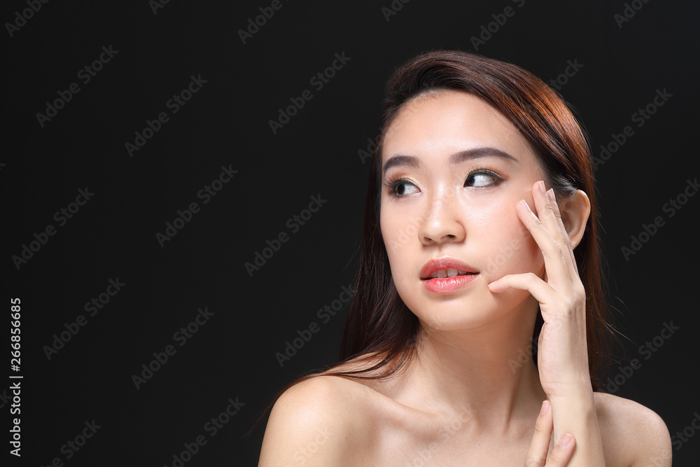 Young beautiful Asian woman makeup dark background 