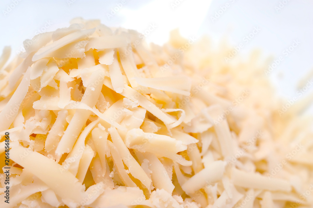 Pile of Grated Cheese on White Background. Organic Farming Dairy Products. Pile of Grated Cheese on White Background. Organic Farming Dairy Products.