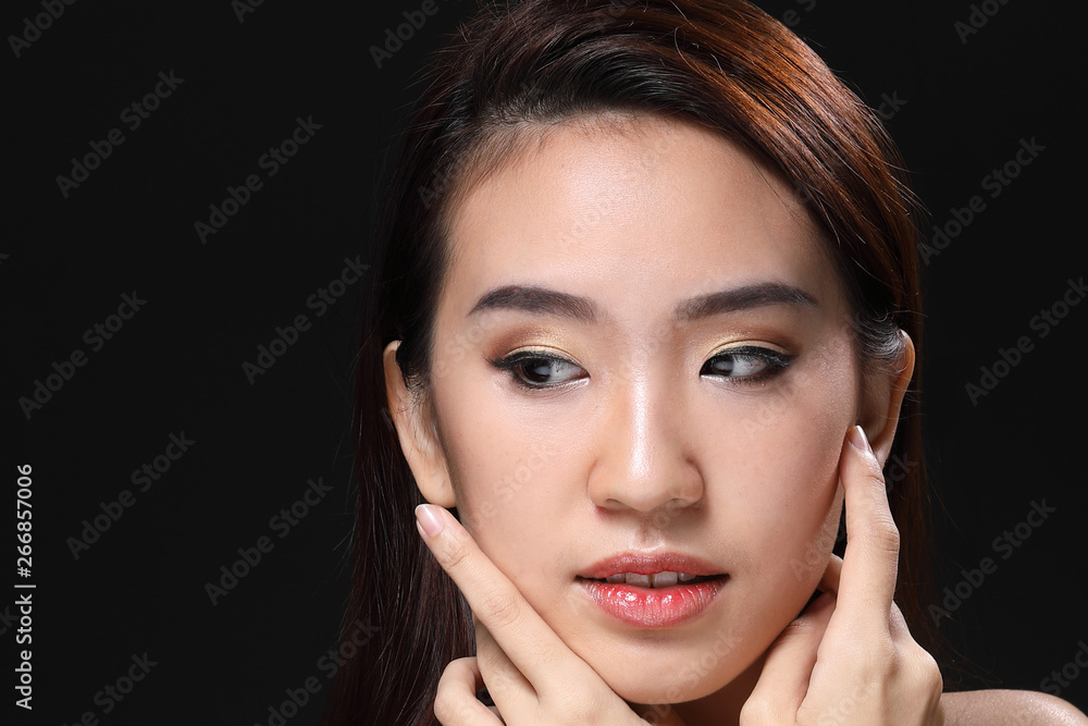 Young beautiful Asian woman makeup dark background Young beautiful Asian woman makeup dark background