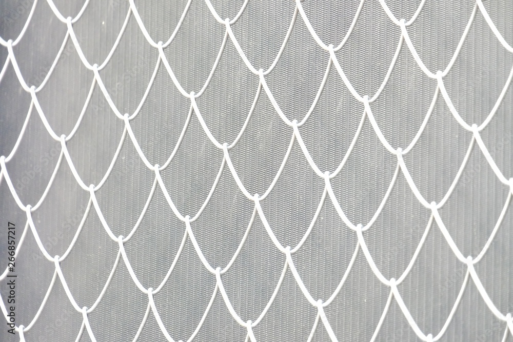 Fototapeta premium Blurred white metal fence on grey template background for backdrop pattern 