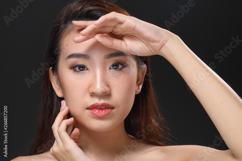 Young beautiful Asian woman makeup dark background 