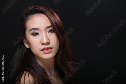 Young beautiful Asian woman makeup dark background 