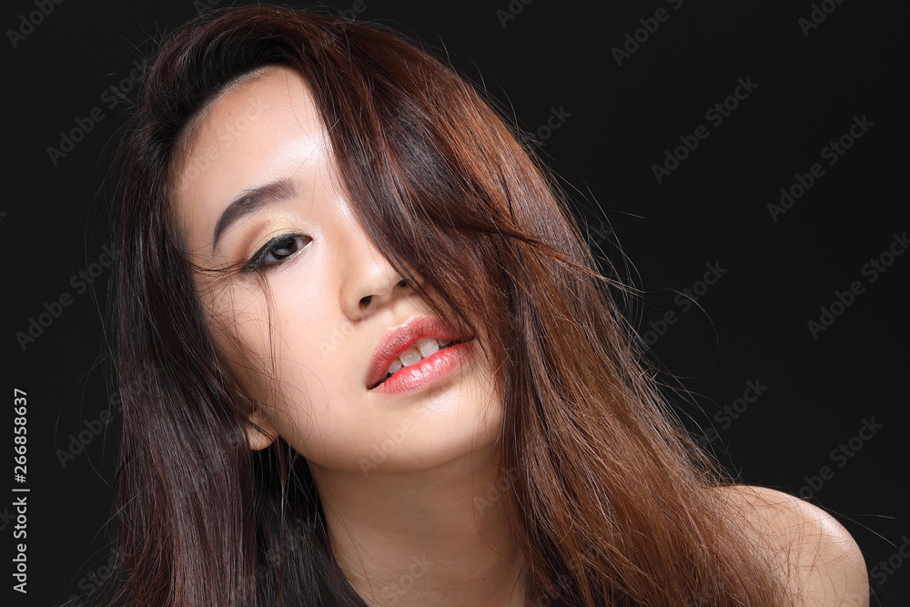 Young beautiful Asian woman makeup dark background Young beautiful Asian woman makeup dark background