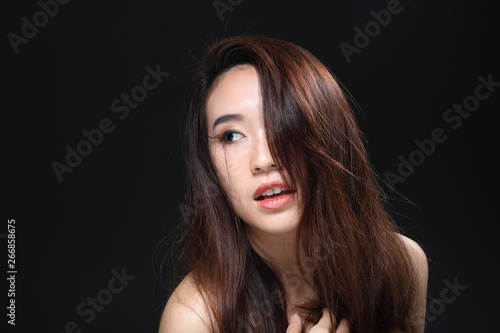 Young beautiful Asian woman makeup dark background 
