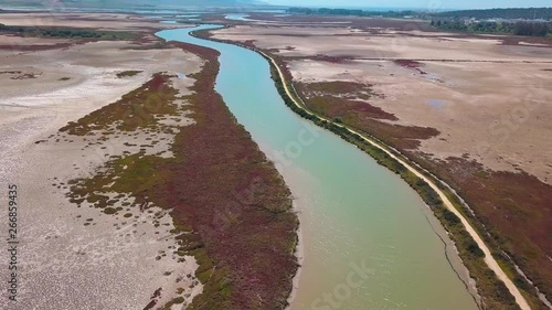 Aerial shot of the Barbate river in Cadiz surrounded by marshes near the coast.