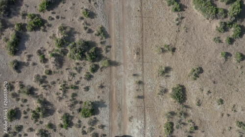 flying forward overhead shot of ATV traversing Nevada desert photo