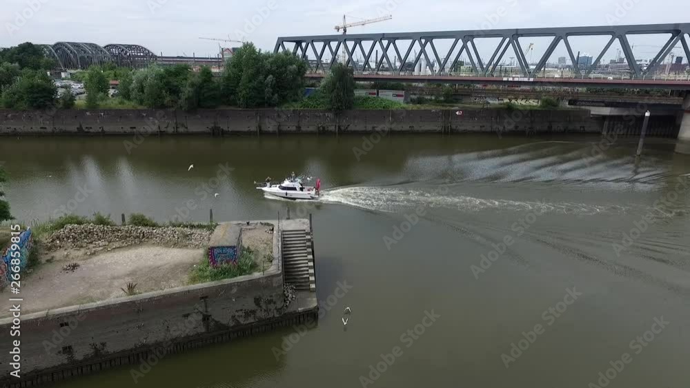 Drone flying and panning at Harbour, following motorboat Drone flying and panning at Harbour, following motorboat