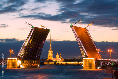 The Divorced Palace Bridge and the Peter and Paul Cathedral on a cloudy white night. Saint-Petersburg, Russia