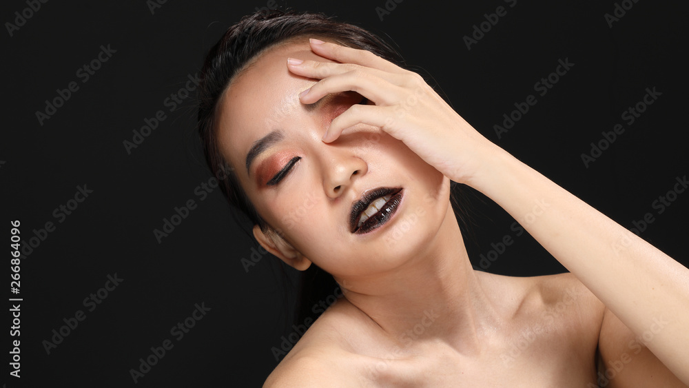 Young beautiful Asian woman makeup dark background Young beautiful Asian woman makeup dark background