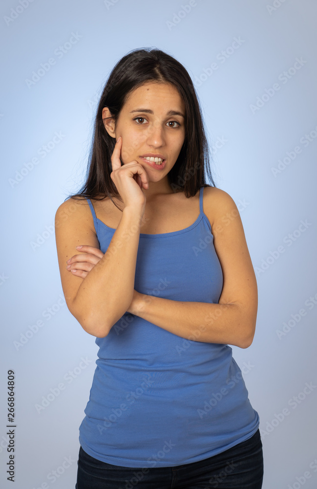 Portrait of young attractive woman with thoughtful expression thinking Portrait of young attractive woman with thoughtful expression thinking