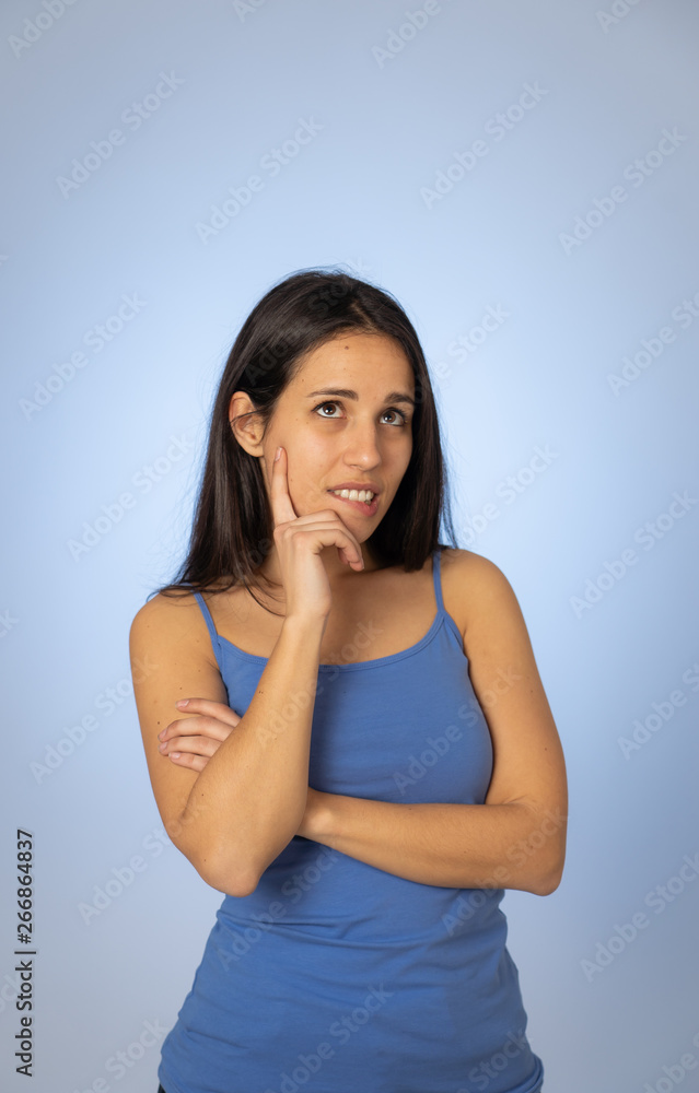 Portrait of young attractive woman with thoughtful expression thinking Portrait of young attractive woman with thoughtful expression thinking
