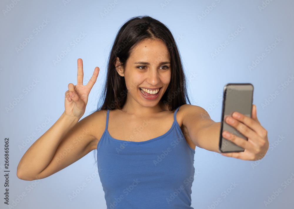 Young teenager woman taking selfie with mobile smart phone for social media Young teenager woman taking selfie with mobile smart phone for social media