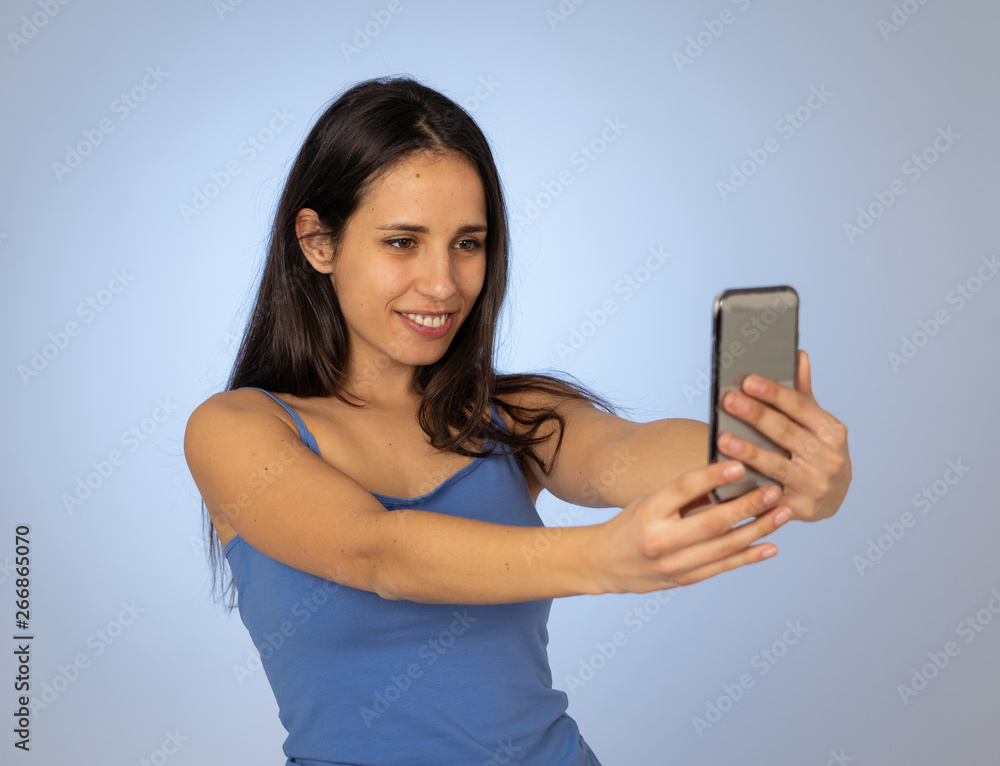 Young teenager woman taking selfie with mobile smart phone for social media Young teenager woman taking selfie with mobile smart phone for social media