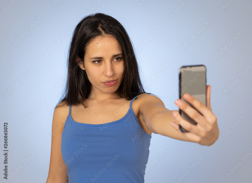 Young teenager woman taking selfie with mobile smart phone for social media Young teenager woman taking selfie with mobile smart phone for social media