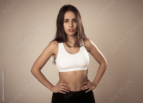 Portrait of sporty beautiful brunette woman in sport clothes looking sensual and fit
