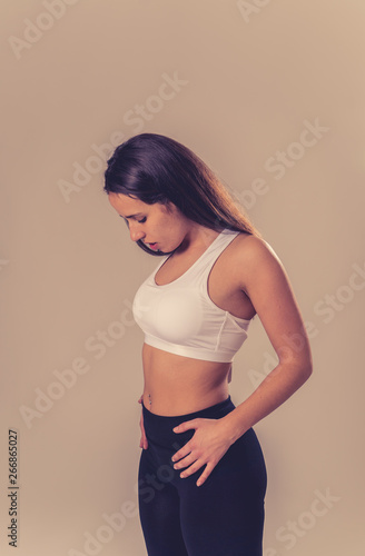 Portrait of sporty beautiful brunette woman in sport clothes looking sensual and fit © SB Arts Media