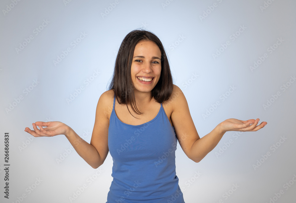 Beautiful woman with no idea, oops sorry or I do not care gesture smiling at the camera Beautiful woman with no idea, oops sorry or I do not care gesture smiling at the camera