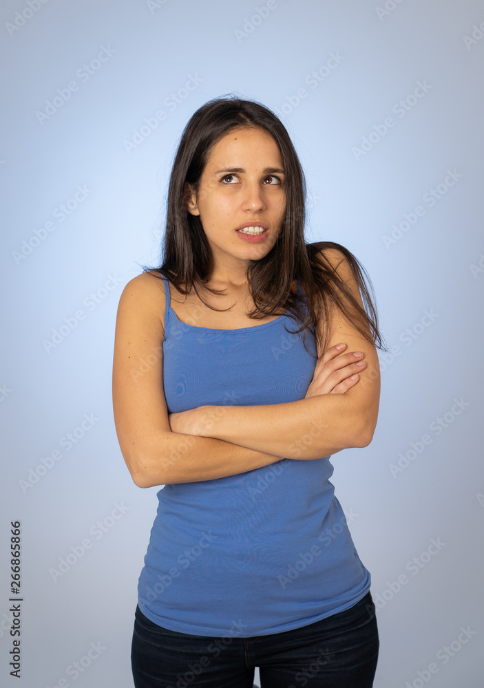 Portrait of unsatisfied latin teenager young woman looking worried with concern face Portrait of unsatisfied latin teenager young woman looking worried with concern face