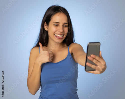 Young teenager woman taking selfie with mobile smart phone for social media