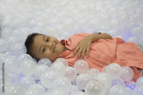 Portrait of asia kid in ball pool photo