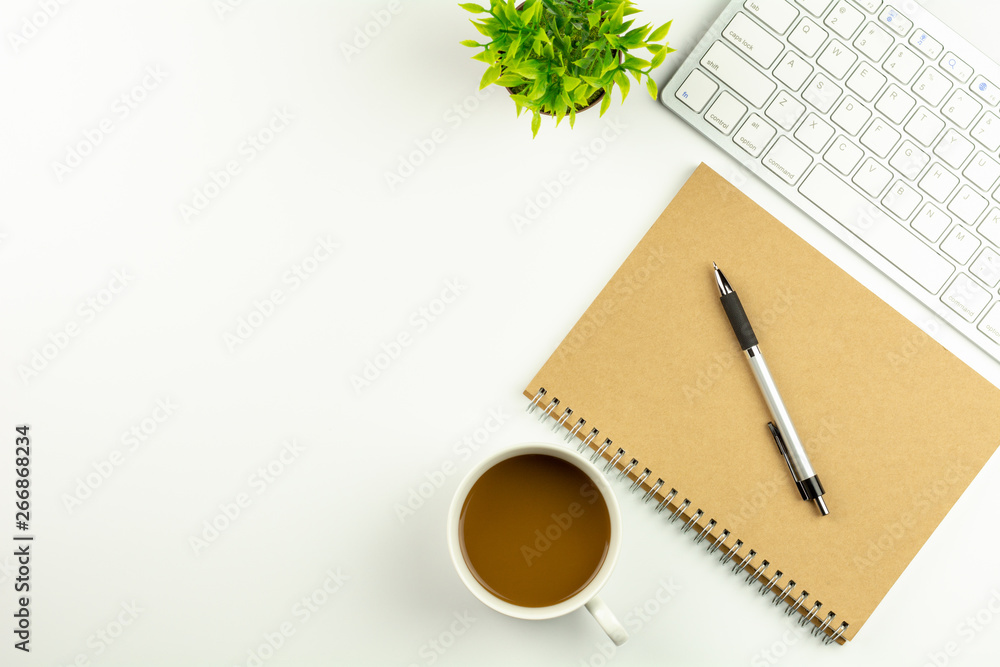 modern white office desk with a computer keyboard, pen, notebook and cup of coffee. - top view with copy space. modern white office desk with a computer keyboard, pen, notebook and cup of coffee. - top view with copy space.