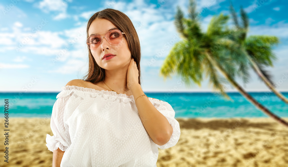 Slim young woman with sunglasses and beach landscape of palms. Slim young woman with sunglasses and beach landscape of palms.