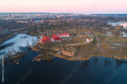 The ancient Korela fortress in the cityscape on April evening (aerial photography). Priozersk, Russia photo