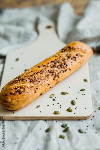 Freshly baked bread on dark grey fabric with seed