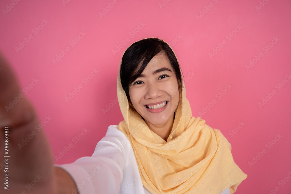 portrait of young muslim woman taking selfie with smart phone portrait of young muslim woman taking selfie with smart phone