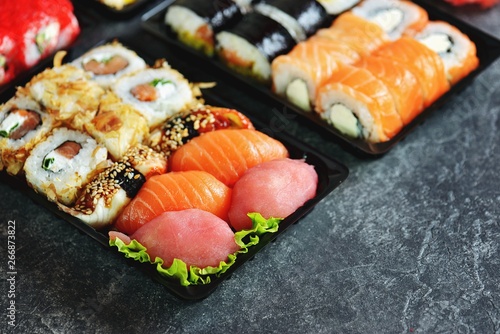 Sushi set with salmon, soft cheese, tuna, smoked eel. Sushi delivery to home. Healthy food. Top view. 