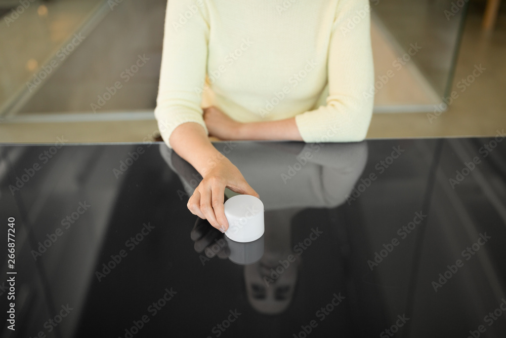 technology and people concept - close up of woman using smart speaker on black interactive panel