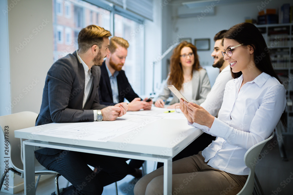 Group of business people collaborating in office Group of business people collaborating in office