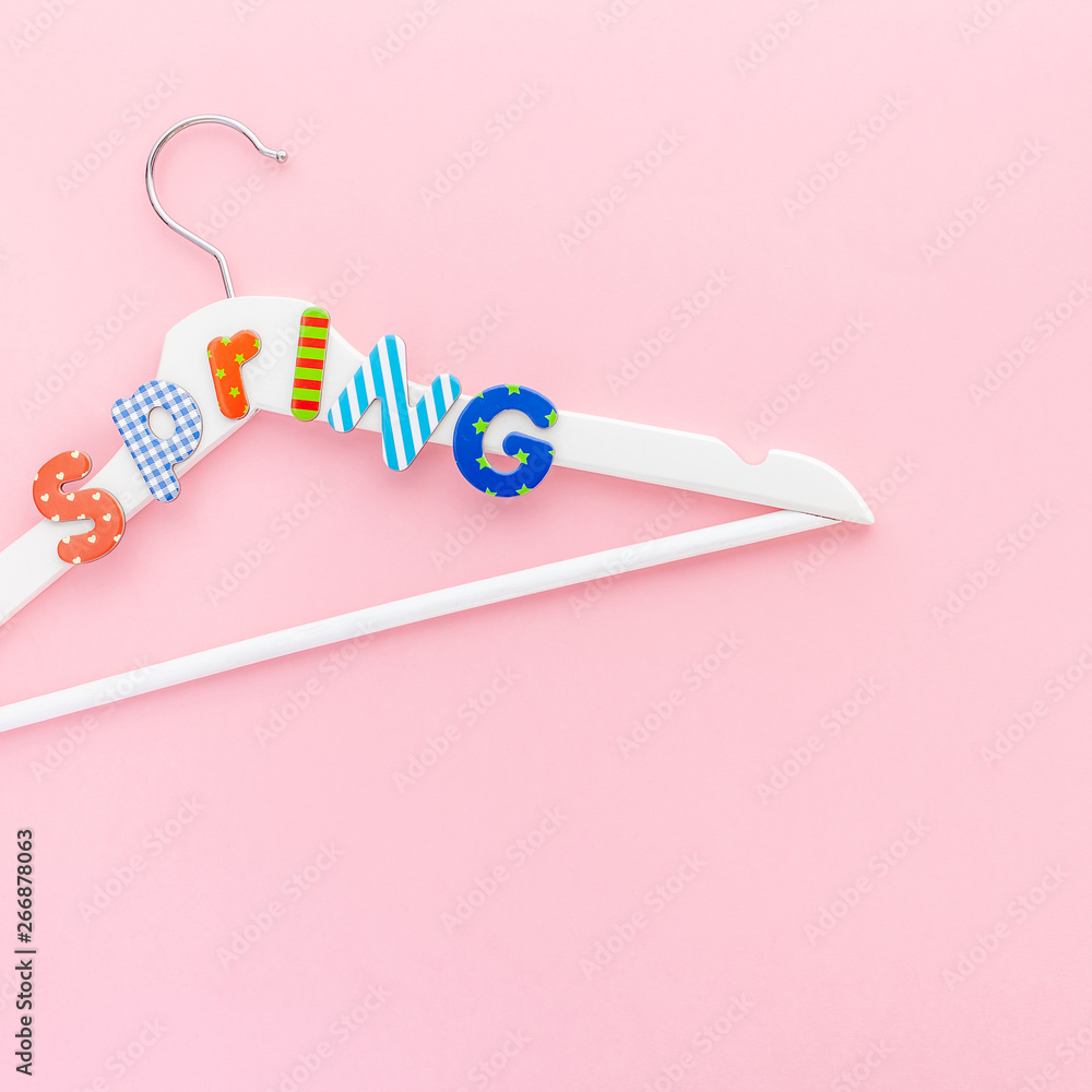 White hangers with sale text on pink background White hangers with sale text on pink background