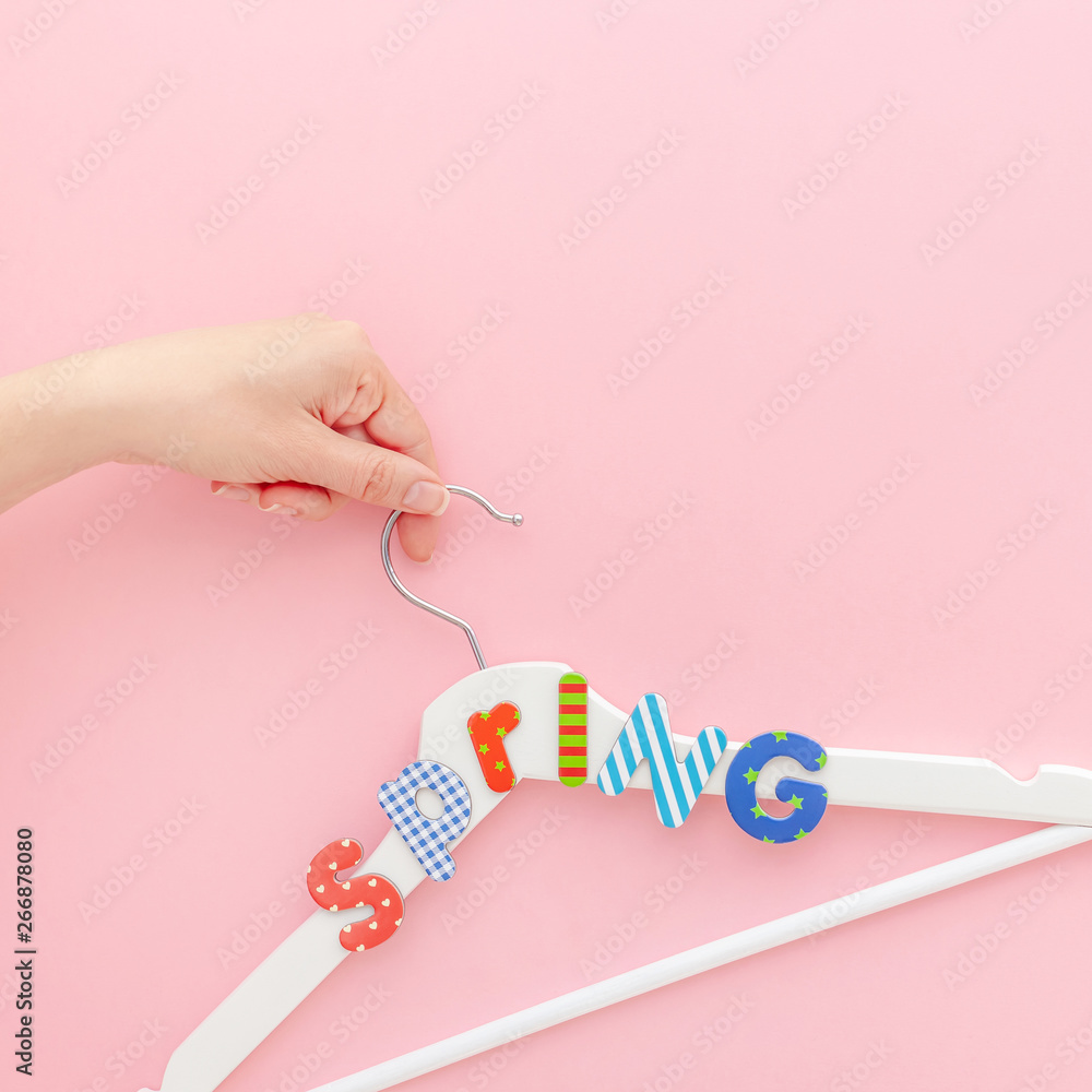 White hangers with sale text on pink background White hangers with sale text on pink background