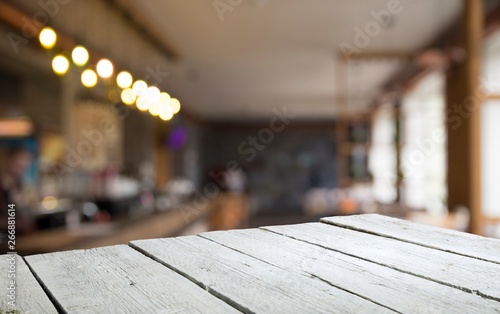 Wallpaper Mural image of wooden table in front of abstract blurred background of resturant lights Torontodigital.ca