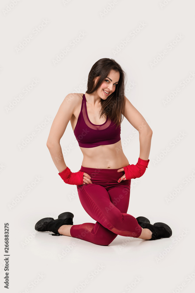 beautiful woman with red boxing tape on wrist doing warm up exercises beautiful woman with red boxing tape on wrist doing warm up exercises