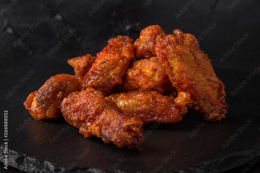 Spicy Wings on black background. Snack to beer. Fast food. Spicy Wings on black background. Snack to beer. Fast food.