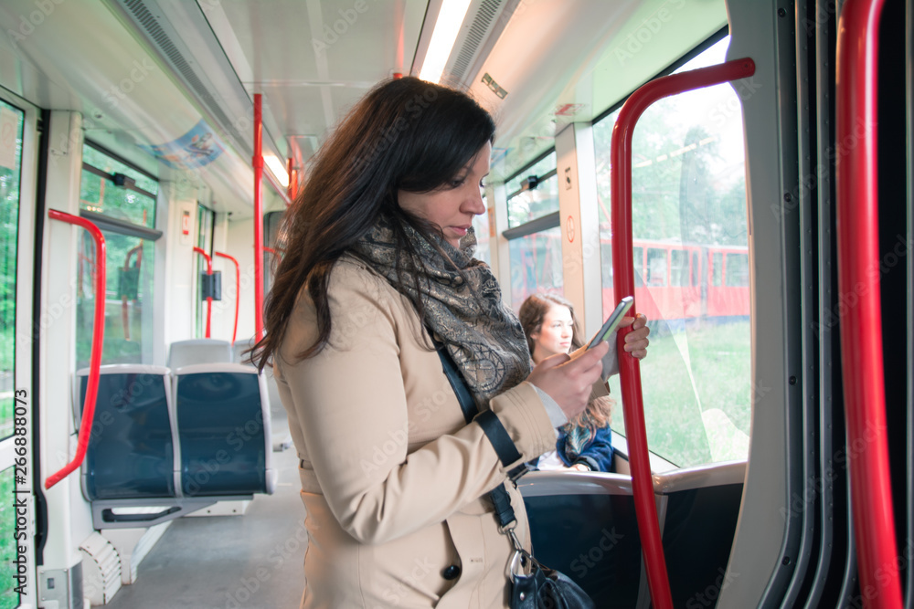 Young woman traveling by bus and using smart phone Young woman traveling by bus and using smart phone