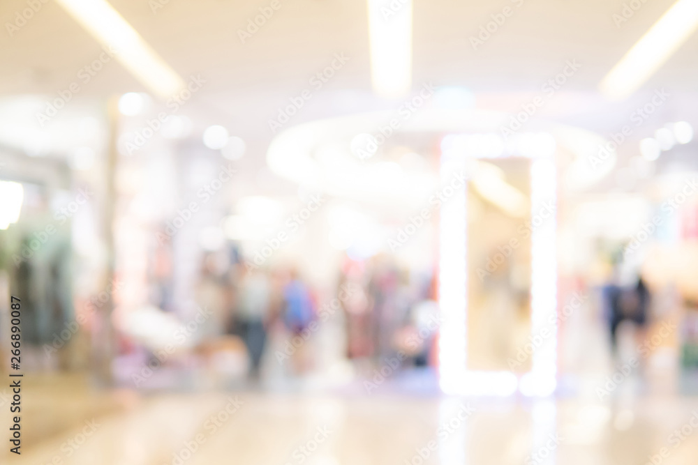 Abstract blur shopping mall corridor. Blurred retail and hall interior in department store. Defocused bokeh effect background or backdrop for business concept.