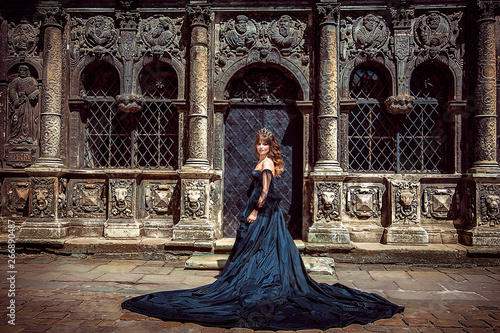 Delightful princess in magnificent black dress in front of Cathedral, Lviv, Ukraine