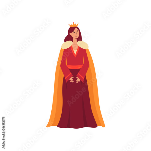 A young medieval queen from a fairy tale stands in a dress, royal mantle and a golden crown.