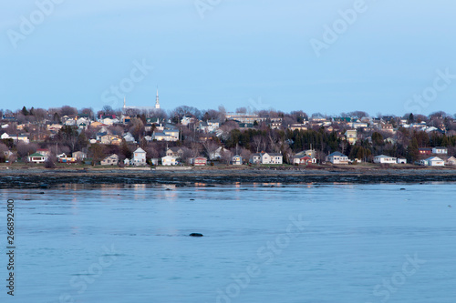 L'Isle-Verte coastal village seen in the distance during a blue hour spring evening, Quebec, Canada