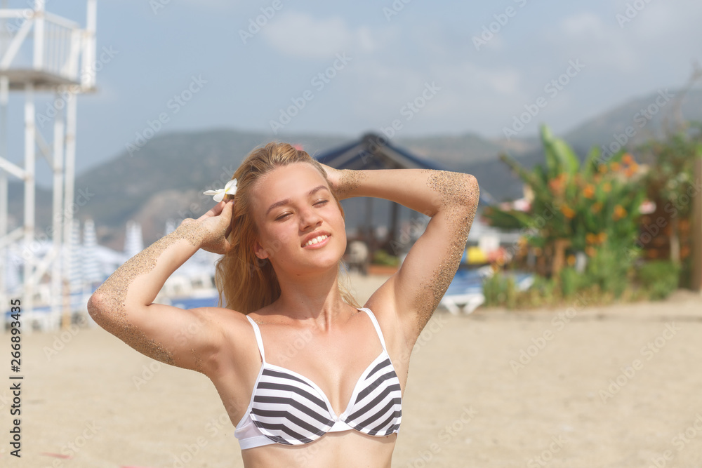 Young girl posing on the beach background Young girl posing on the beach background