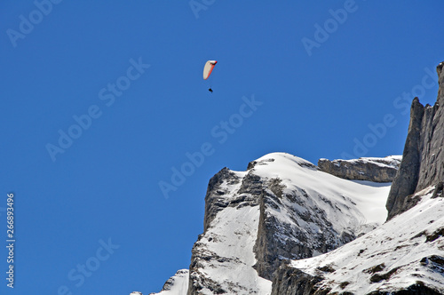 paragliding over swiss alps peak