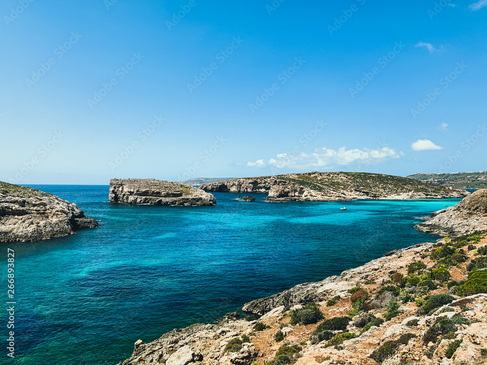 Islands with clear turquoise water in Mediterranean sea. Nature summer seascape in Malta. Travel and tourism in summer time concept. Malta, Comino Island