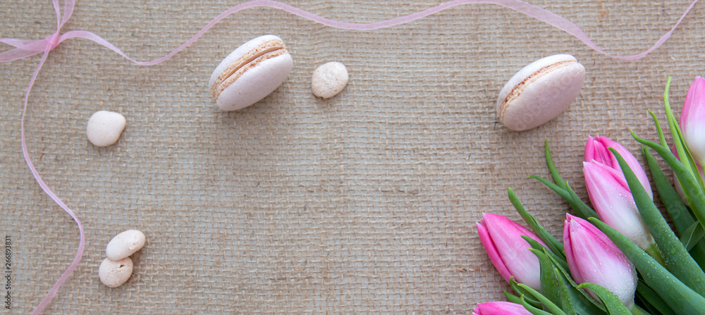 Mother's day background with tulips bouquet and pink macarons. Mother's day background with tulips bouquet and pink macarons.